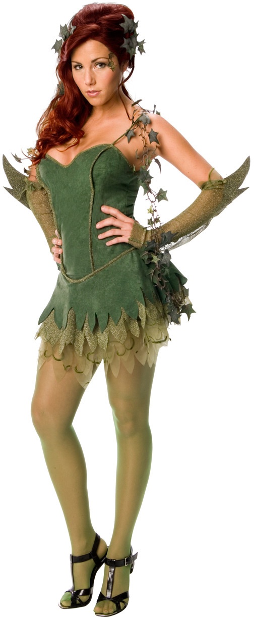 a woman dressed in a green costume with leaves on her arms and legs, posing for the camera