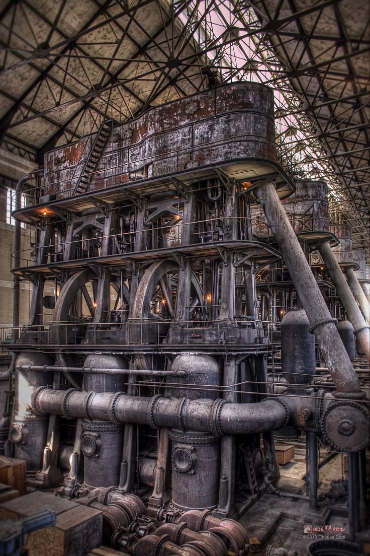 an old factory with pipes and machinery inside