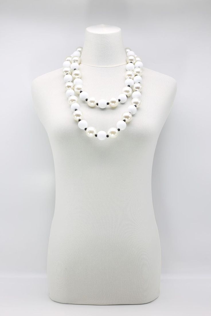 Description: 22 mm round wooden beads & 25 mm faux pearls Length: Approximately 140 cm Available colours & Product codes: Black/White - NL2177-01 White/White - NL2177-14 White Jewelry With Wooden Beads, Luxury Long White Beaded Necklaces, Elegant White Jewelry With Wooden Beads, Elegant White Necklaces With Wooden Beads, Elegant White Beaded Necklaces With Wooden Beads, Elegant White Beaded Necklace With Wooden Beads, White Long Necklace With Round Beads, White High Luster Round Beads Necklace, Elegant White Wooden Beaded Necklaces