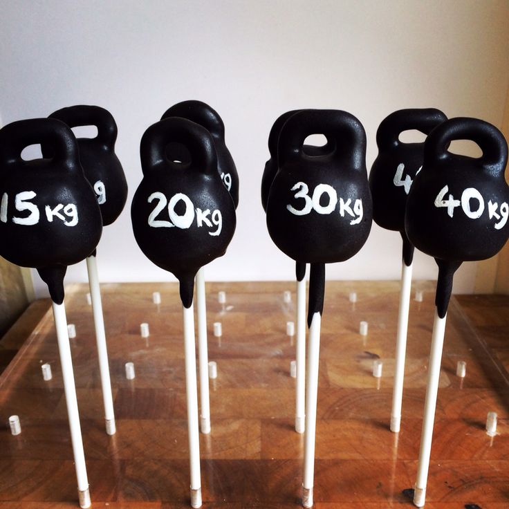 four black kettles are on sticks with white handles and the numbers 30 - 40