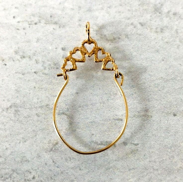 This vintage solid 14k gold charm holder pendant will hold all your favorite charms!  Create your very own version of a "penca de balangandan", the traditional charm cluster from Brazil. The pendant measures approximately 1 1/2" tall by 3/4" at the widest point, and five diamond-cut hearts form the top arch. It is in excellent condition, with a slight bend to the lower portion due to regular use. It won't be visible once charms are added. The bail will fit chains up to 2.5 mm wide. This charm ho Brass Heart Charm Pendant Jewelry, Brass Heart Pendant Jewelry With Charms, Brass Heart Pendant Charms Jewelry, Traditional Heart Charm Pendant Jewelry, Heart Charm Dangle Jewelry In Brass, Brass Heart Charm Dangle Jewelry, Traditional Gold Jewelry With Heart Charm, Yellow Gold Jewelry With Heart Pendant And Dangling Charms, Yellow Gold Brass Charms For Jewelry Making