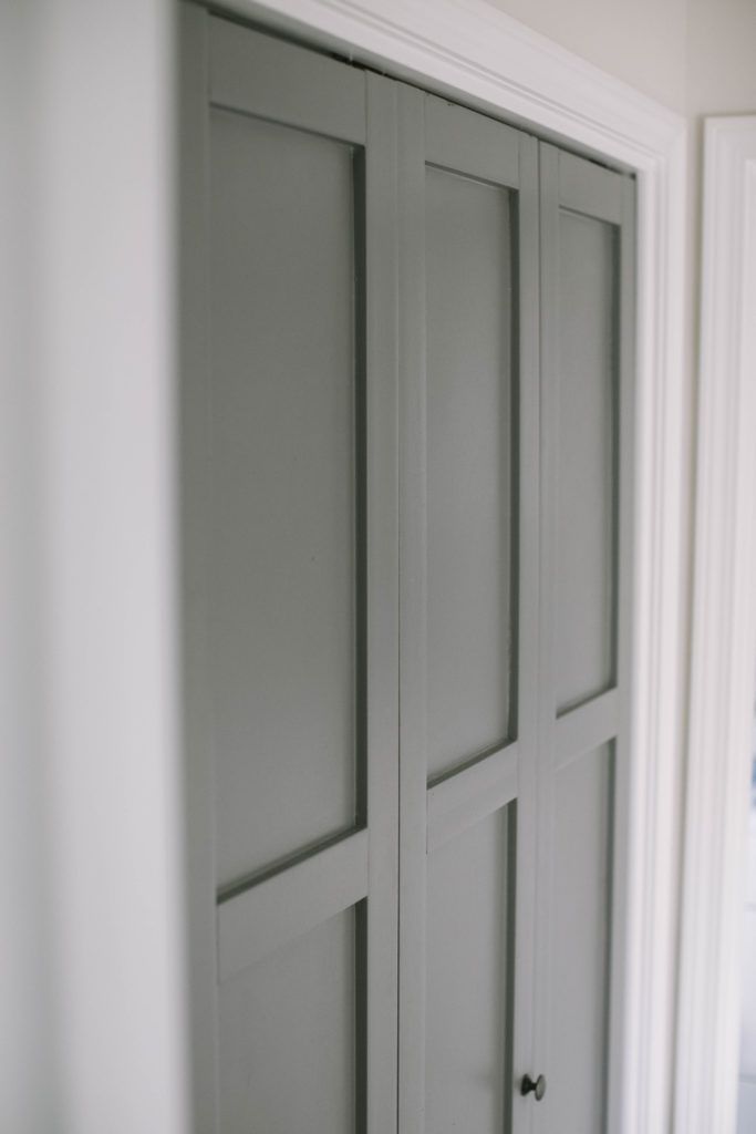 an open closet door in the corner of a room