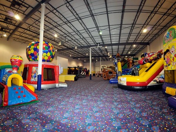 an indoor play area with slides and inflatables