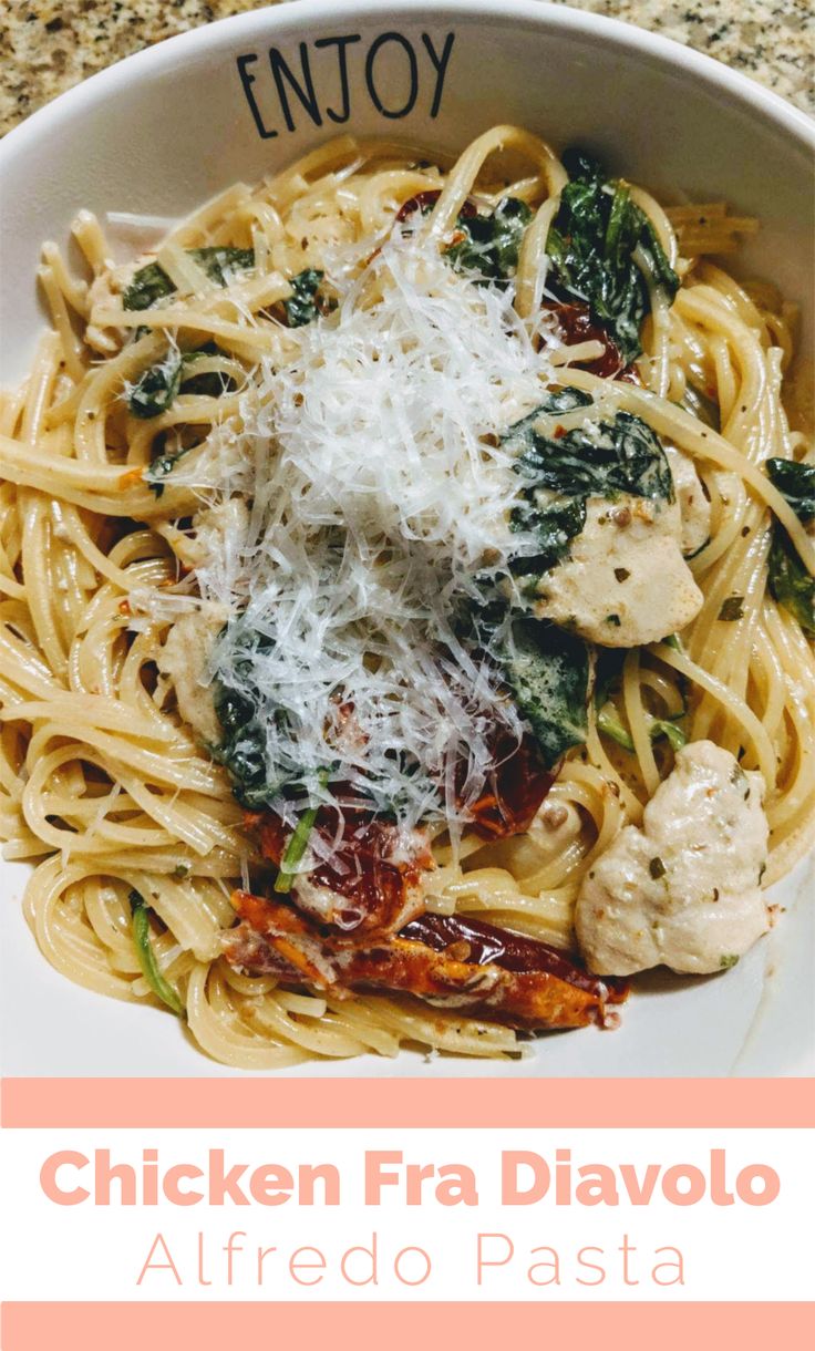 chicken faa divolo with alfredo sauce and spinach in a white bowl