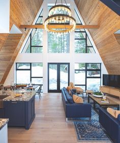 a living room filled with furniture and a chandelier hanging over the top of it