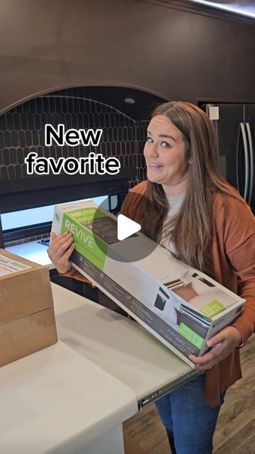 a woman holding a new favorite pizza box