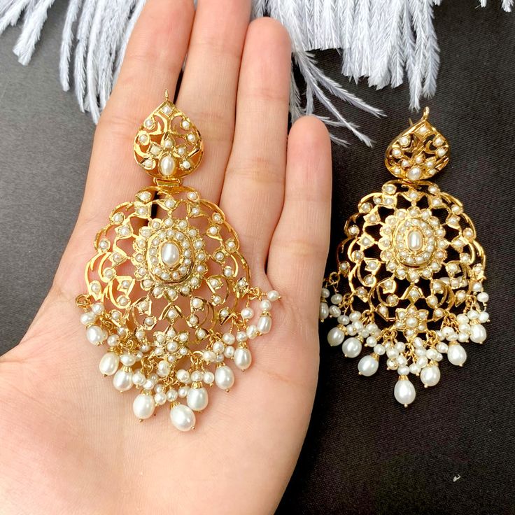 Enhance your style with a touch of elegance. Adorn yourself with these exquisite freshwater pearl earrings, crafted with precision and plated in gold over sterling silver. Elevate your look and make a statement of opulence and sophistication. Weight - 31 GMs Height - 8.75 cm Width - 4.25 cm Elegant White Chandbali Earrings, Elegant Chandbali Pearl Earrings For Party, Elegant Chandbali Pearl Earrings For Festive Occasions, Elegant Chandbali Earrings, Elegant Chandbali Bridal Earrings For Pierced Ears, Elegant Bridal Chandbali Earrings, Elegant Chandbali Bridal Earrings With Elegant Design, Elegant White Earrings For Festive Occasions, Elegant Pearl Drop Earrings For Festive Occasions