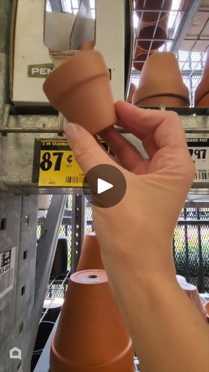 a person is holding clay pots in their hand while they are working on the project