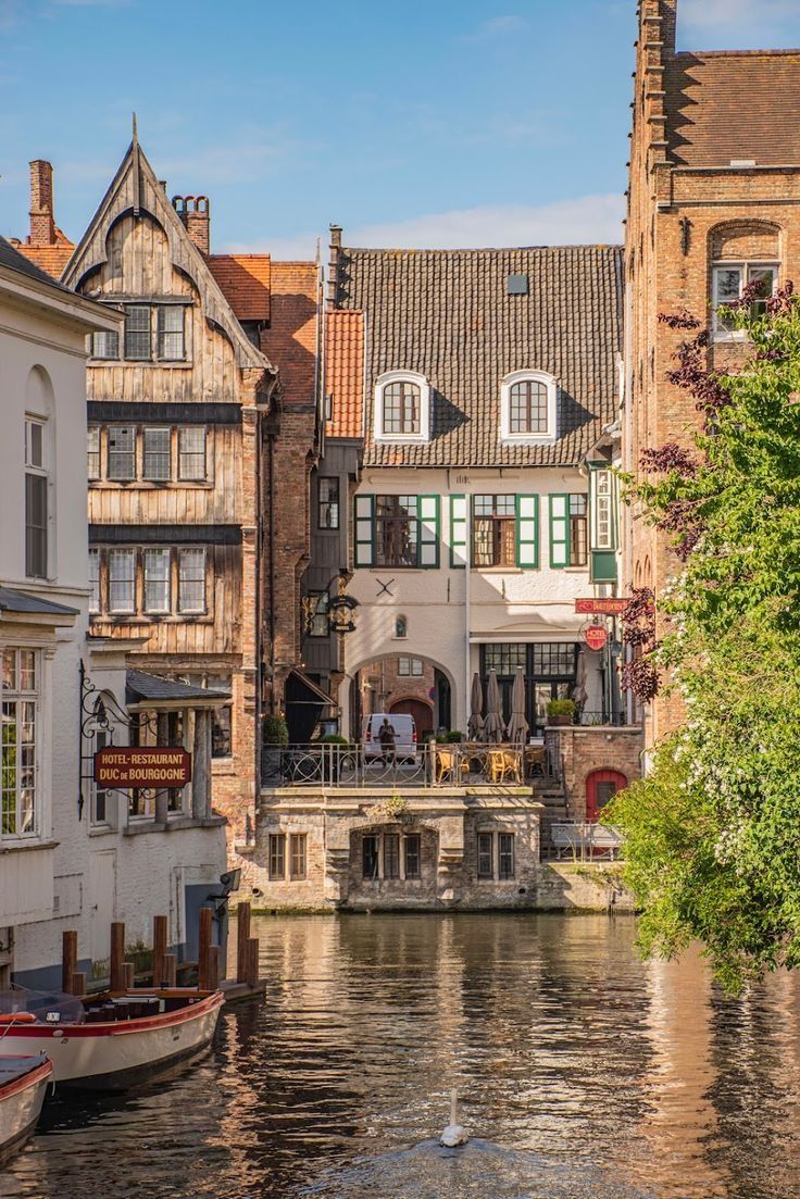 boats are parked on the water in front of buildings