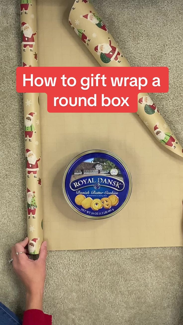 a person holding a roll of wrapping paper with the words how to gift wrap a round box