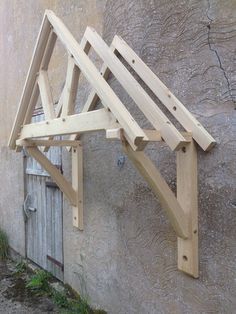 an unfinished wooden structure on the side of a building