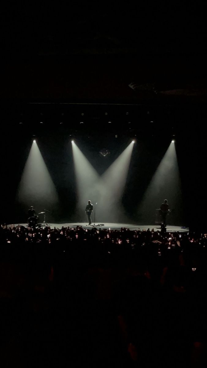 the stage is lit up with three spotlights