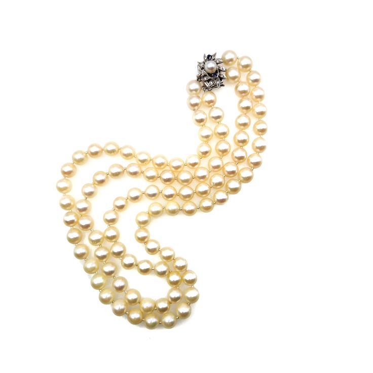 "Pearls are the epitome of style and grace, with their internal glow and lovely luster. This is a gorgeous vintage double-strand pearl necklace from the 1950s crafted with matched 8.5-8.8mm cultured Japanese Akoya pearls. The round pearls have a cream overtone and subtle luster and are secured with a fancy clasp decorated with two natural round-cut sapphires and ten single-cut diamonds in 14K white gold. This timeless necklace is excellent for a vintage-loving bride or a June baby! Pearls have a Classic Double Strand Wedding Necklaces, Classic Evening Necklaces, Vintage Yellow Gold Single Strand Necklace, Vintage Double Strand Jewelry For Formal Occasions, Classic Evening Necklace With 17 Jewels, Vintage Round Pearl Necklace For Formal Occasions, Elegant Double Strand Cream Necklace, Vintage Single Strand Jewelry For Formal Occasions, Vintage Pearl Necklace For Formal Occasions