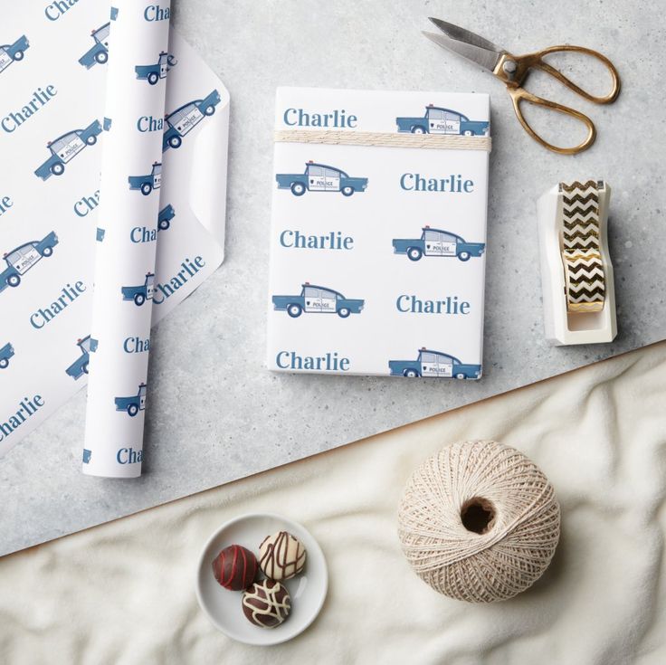 wrapping paper, twine and other crafting supplies laid out on top of a table