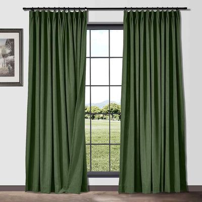 a green curtain hanging on the side of a window