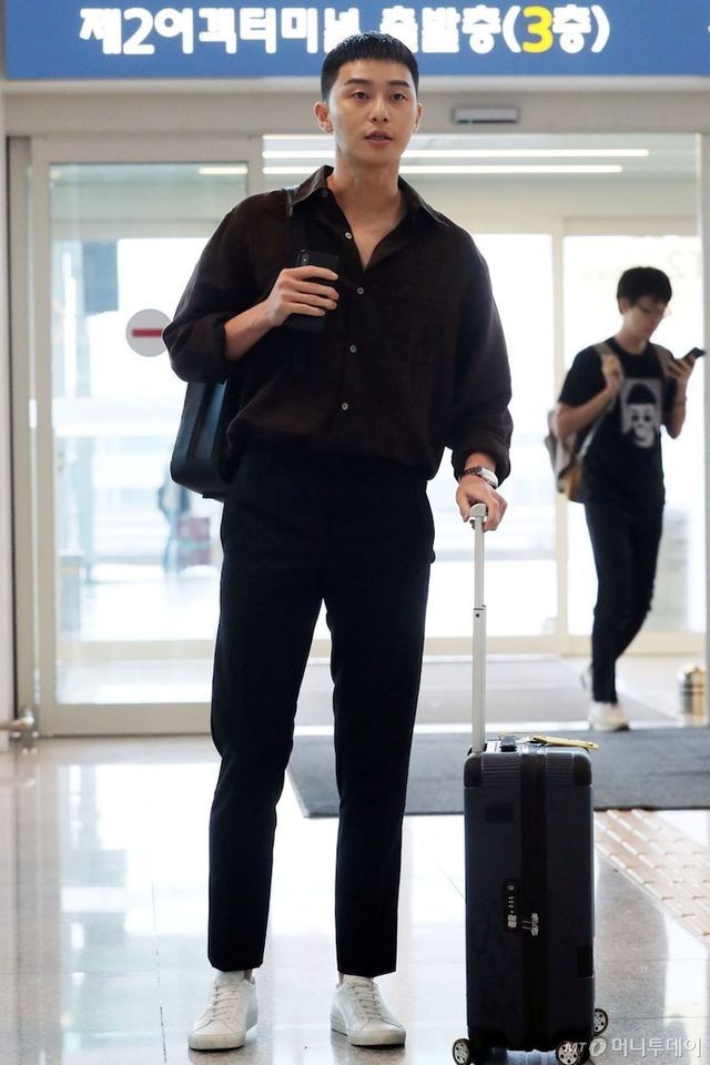 a man with a suitcase is walking through an airport