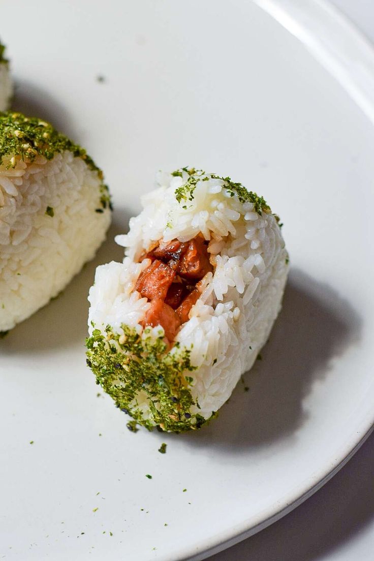 two pieces of sushi on a white plate