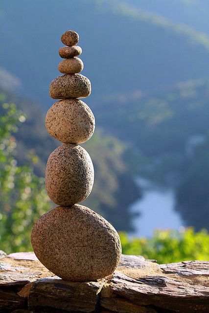 a stack of rocks sitting on top of a wooden table