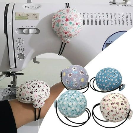 the sewing machine has four balls attached to it's head and is being sewn