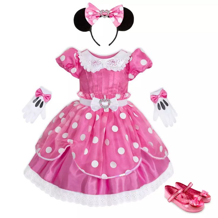 a pink minnie mouse dress with white polka dots on the skirt and matching headband