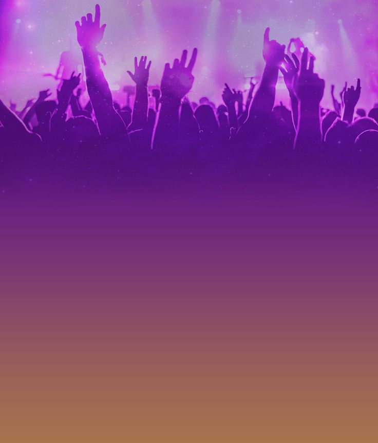 a crowd of people with their hands up in the air at a concert or show