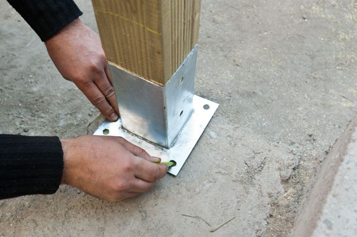 a man is working on a piece of metal that has been placed in the ground