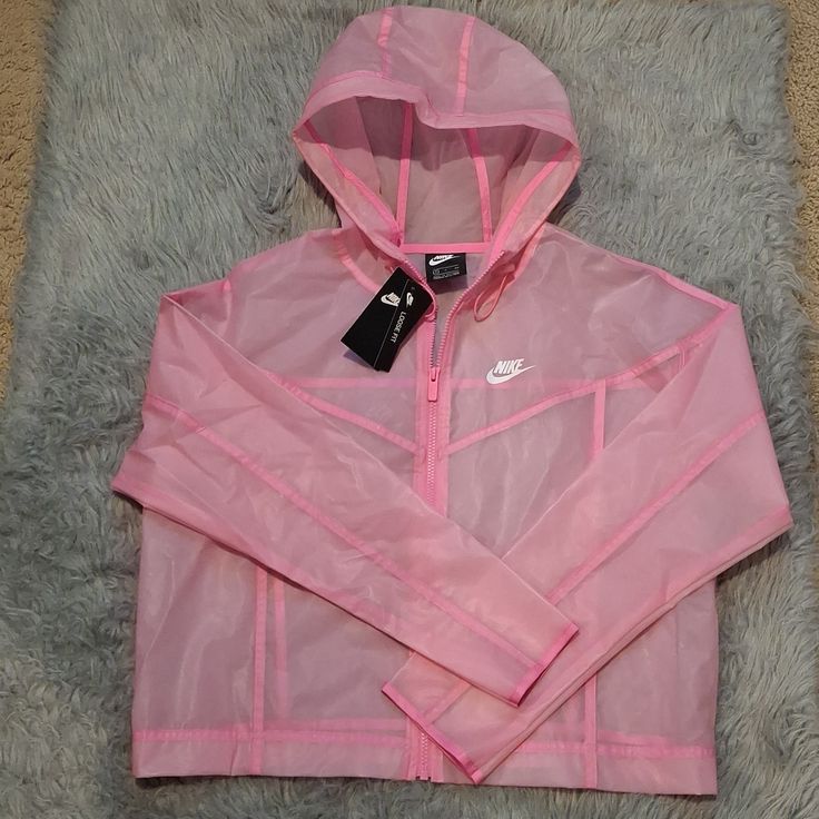 Nike Loose Fit Small Rain Coat, Clear Pink With Darker Pink Details, Non Rusting Zipper And Hood With Adjustable Elastic. Perfect To Cover Your Favorite Outfit Or To Exercise In Nike Hooded Outerwear For Spring, Fitted Windbreaker With Pockets For Spring, Nike Casual Spring Windbreaker, Fitted Nylon Windbreaker For Spring, Fitted Hooded Windbreaker For Spring, Pink Nylon Outerwear For Spring, Nike Spring Outerwear With Pockets, Nike Hooded Windbreaker For Spring, Nike Hooded Spring Windbreaker