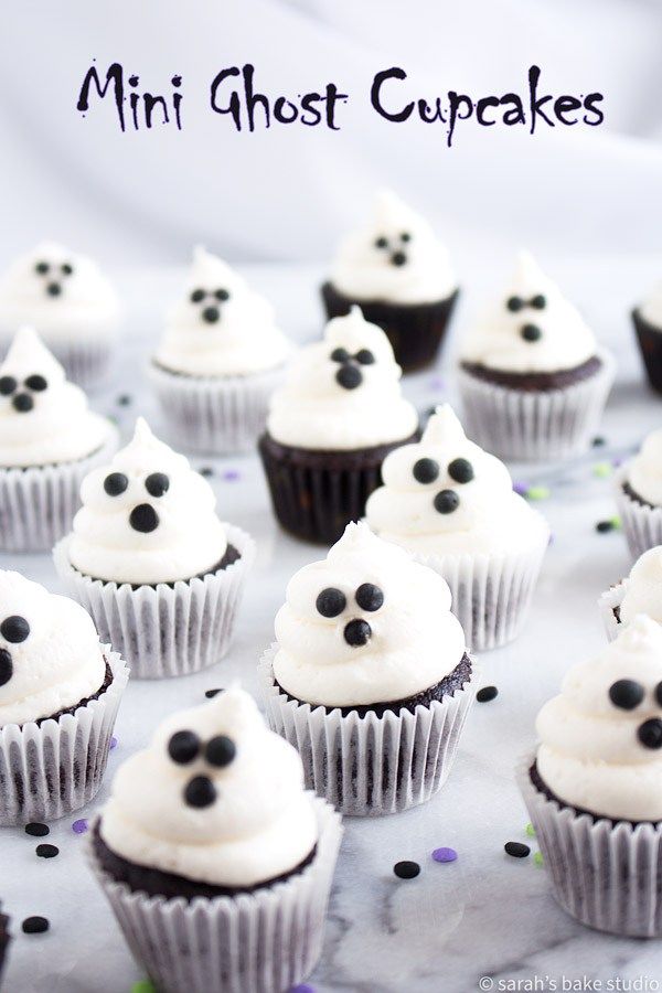 cupcakes decorated with white frosting and black eyes