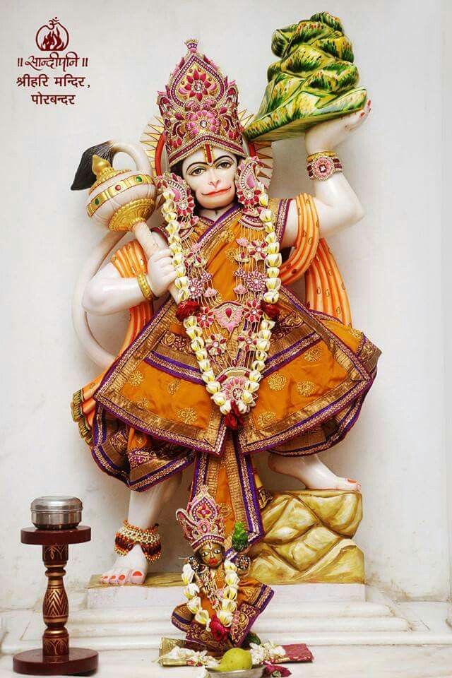 a statue of the god person with fruits on his head and hands in front of him