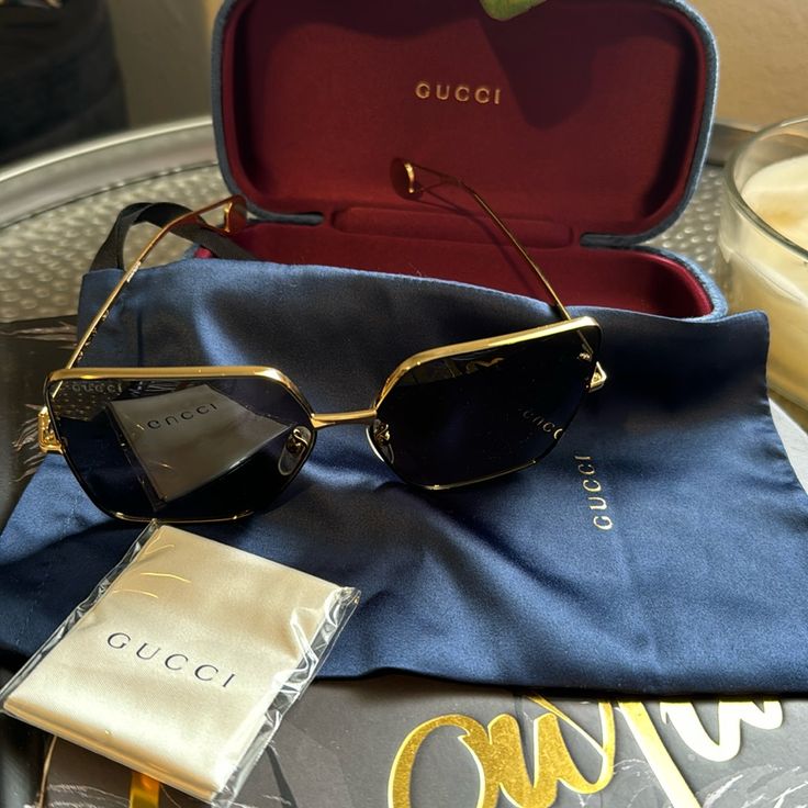 These Gorgeous Gucci, Sunglasses Square Shaped With Gold Trim Are Almost Brand. New, I Wore Them Twice And It Comes With An Unopened Cleaner And A Dust Bag Along With The Case In Navy Blue Chic Gold Gucci Sunglasses, Gold Gucci Sunglasses, Luxury Gucci Shield Sunglasses, Gucci Cat-eye Sunglasses With Uva Protection, Gucci Luxury Anti-reflective Shield Sunglasses, Gucci Accessories, Gucci Sunglasses, Gucci Black, Colored Sunglasses