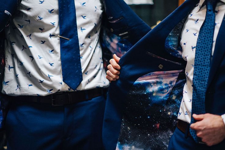 two men in suits and ties standing next to each other with space printed on them