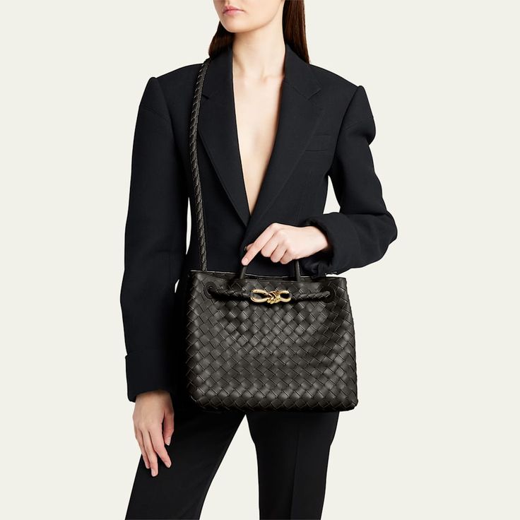 Bottega Veneta "Andiamo" top handle bag in  intreccio  lambskin leather  Rolled top handle, 3.5" drop Shoulder strap Can be worn as a top handle or shoulder bag  Open top with magnetic closure; metal knot center strap  Approx. 9.8"H x 11.6"W x 4.3"D Made in Italy Black Travertine, Andiamo Bag, Bottega Veneta Andiamo, Leather Roll, Open Top, Handle Bag, Back To Black, Lambskin Leather, Leather Top