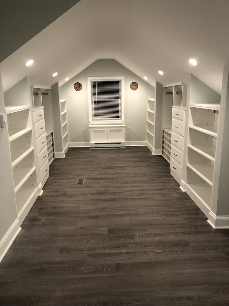 an empty room with white shelving in the ceiling and wood flooring on the walls