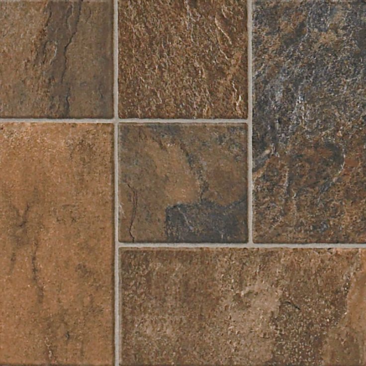 a close up view of a tile floor with brown and tan colors on it's surface