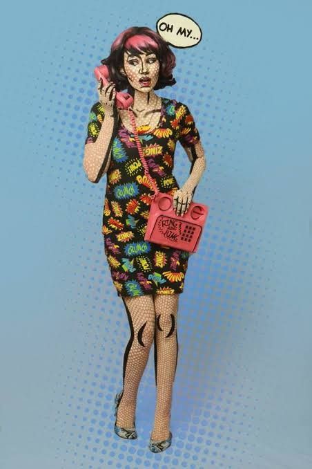 a woman in a dress holding a cell phone to her ear with an on my face speech bubble above her head