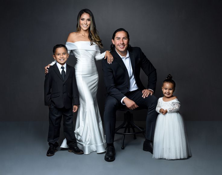 a family posing for a photo in formal wear