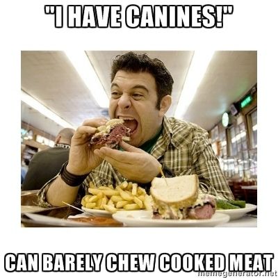 a man eating a sandwich and fries with caption that reads, i have canines can barely chew cooked meat