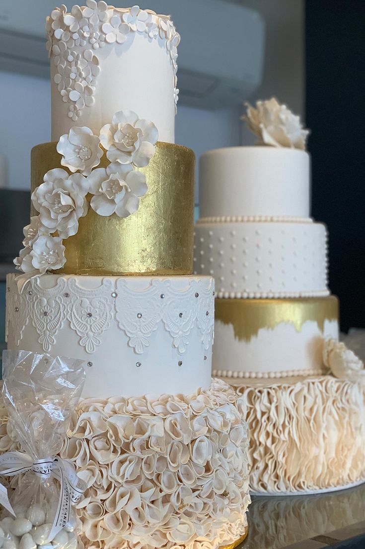 three tiered wedding cake with white and gold decorations