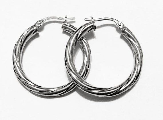 Fancy swirly hoop earrings:metal        : solid 14k yellow gold/solid white goldthick          = 3 mmweight       = 2 grdiameter   = 1"inch (25mm)closure     : snap downmade        : in Italy Modern Twist Hoop Earrings As Gift With Polished Finish, Modern Twist Polished Hoop Earrings As Gift, Modern Twist Small Hoop Jewelry Gift, Modern Twist Small Hoop Earrings For Gift, Modern Twist Small Hoop Earrings As Gift, Modern Twist Silver Hoop Jewelry, Trendy Hypoallergenic Jewelry For Anniversary, White Gold Hoop Earrings With Modern Twist, Modern Twist Huggie Jewelry Gift