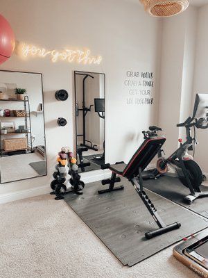 a home gym with exercise equipment and mirrors