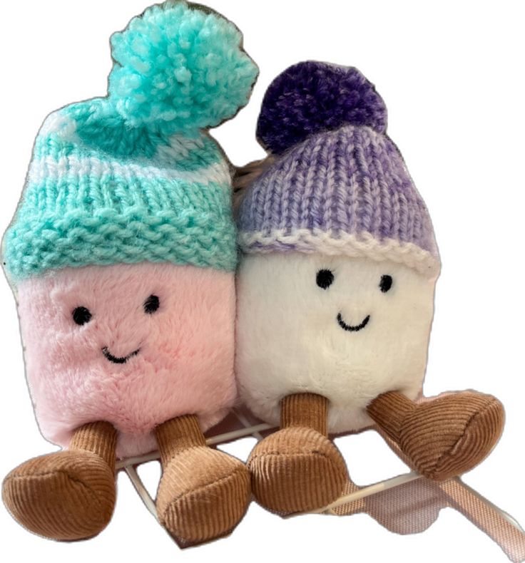 two knitted toys sitting on top of each other