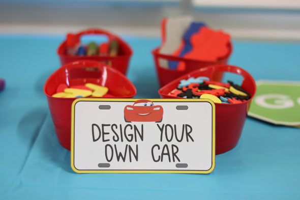 there is a sign that says design your own car in front of some red bowls