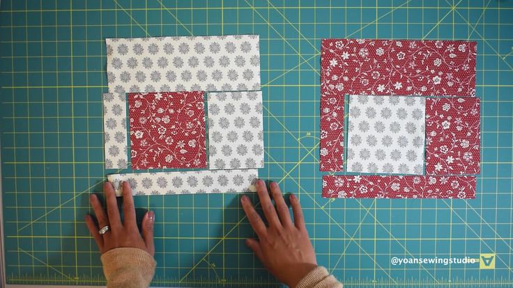 someone is cutting out the squares on top of each other to make a quilted wall hanging