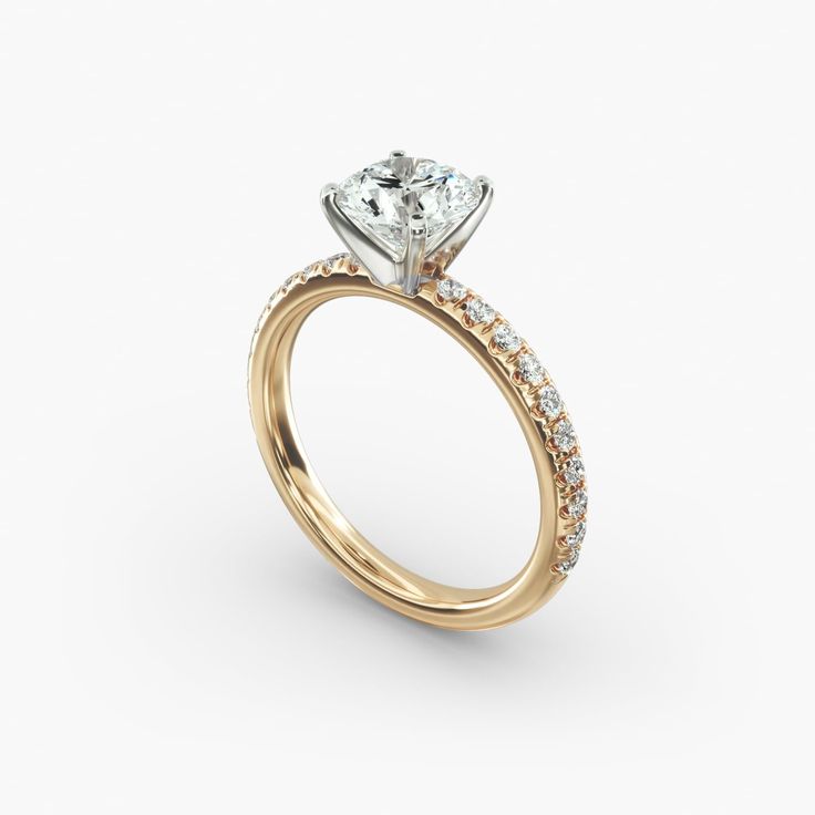 a yellow gold engagement ring with diamonds on the side