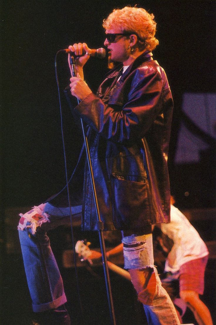 a man standing on top of a stage holding a microphone