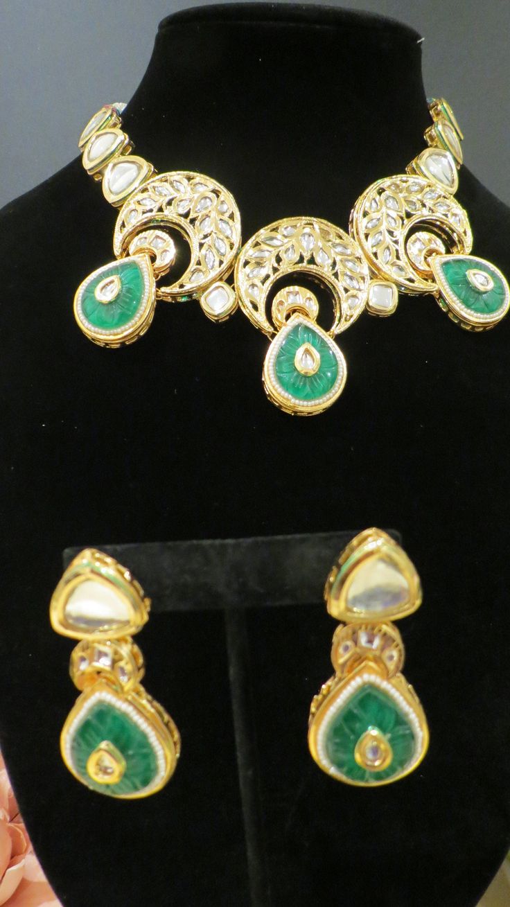 This beautiful choker is a modern twist to traditional jewelry and comes in a gold finish with green stones to match any outfit as desired. The choker is made of high quality stones and is a statement piece that can be dressed accordingly. The set comes with matching earrings for a complete look. Gold Plated Green Jewelry Sets For Festivals, Green Gold-plated Kundan Necklace For Festivals, Green Gold Plated Kundan Necklace For Festivals, Green Gold-plated Jewelry Sets For Festivals, Traditional Green Earrings With Jewels, Traditional Green Jeweled Earrings, Festive Green Gold Plated Jewelry Sets, Green Kundan Jewelry With Matching Earrings, Green Kundan Necklace With Jewels For Formal Occasions