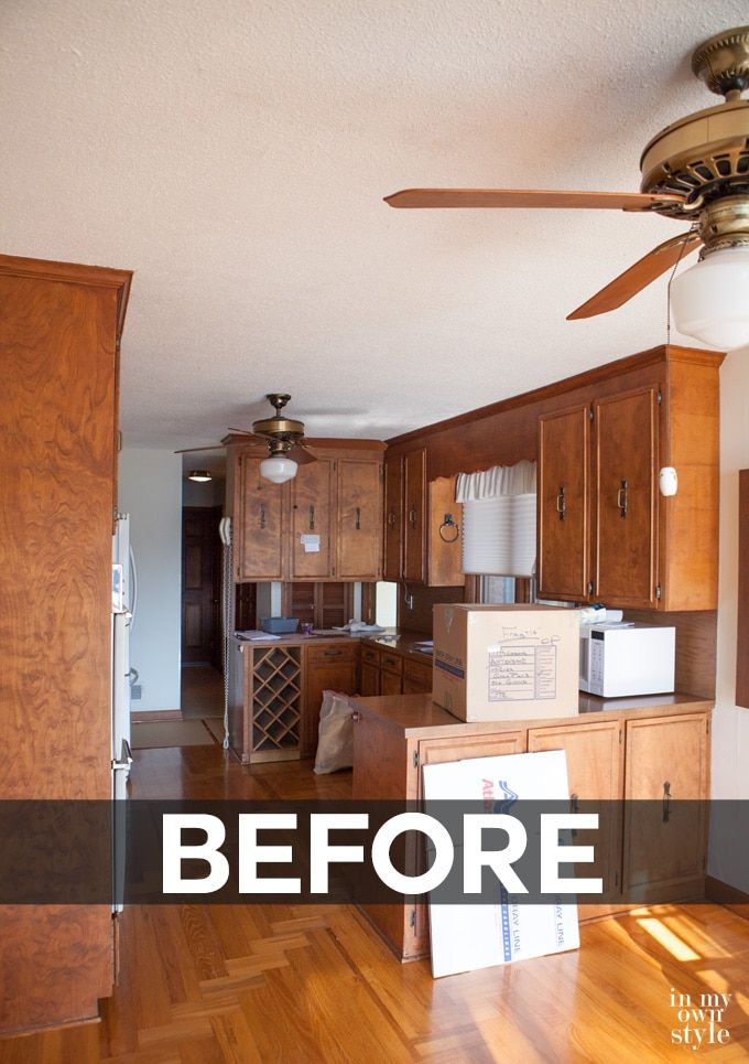 an empty kitchen with wood floors and ceiling fan in the center, before and after remodeling