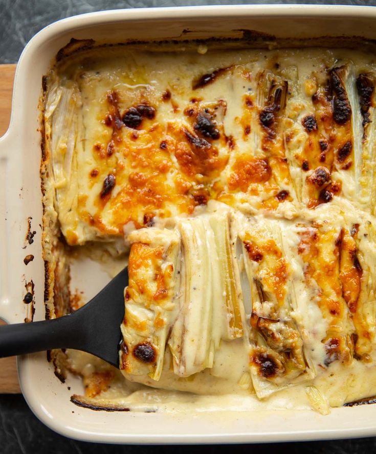 a casserole dish with cheese and meat in it