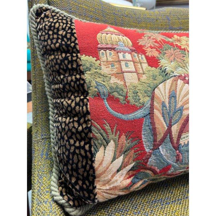 a close up of a cushion on a chair with an animal print pattern and black trim