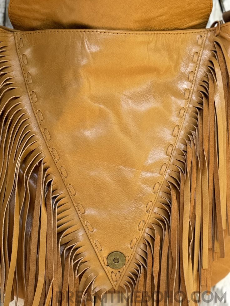 This remarkable, handcrafted leather fringe boho handbag is an absolute showstopper! Meticulously crafted with love, this unique bag is a must-have for any boho-enthusiast. Its captivating, detail will make a bold statement. Just drape the bag over your shoulder and prepare to turn heads with its effortless fashion. Hancrafted Genuine Leather Lined Feature Stone Zip Close Adjustable Cross Body Strap Stud detail Inside bag has a zip pocket and two open pockets for keys, phone, lipstick etc Measur Boho Handbag, Boho Handbags, Effortless Fashion, Inside Bag, Unique Bags, Boho Bag, Leather Fringe, Handcrafted Leather, Effortless Style